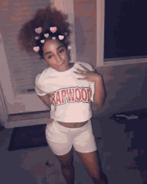 a woman wearing a rapwood t-shirt and shorts