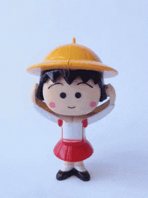 a yellow hat with a hole in the middle is on a toy