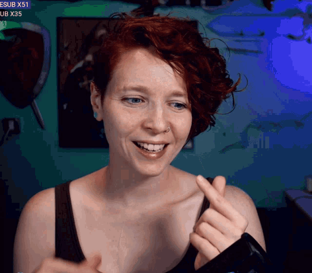 a woman is smiling in front of a screen that says esub x51 and ub x35