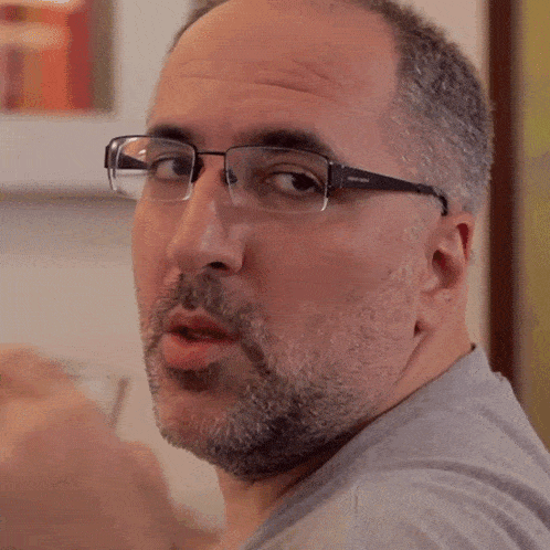 a man drinking from a glass with a pair of glasses that say ' steve madden ' on them