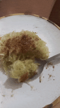a plate of food with a spoon in it