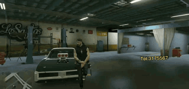 a man is sitting in front of a car in a garage that says h & s motors aksesuar aracin sesini dinle