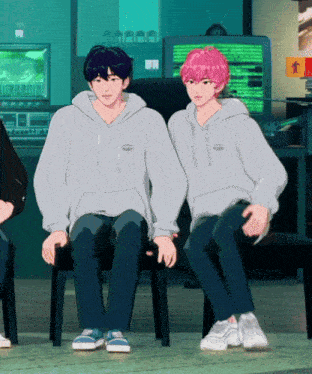 two anime characters are sitting next to each other in front of a computer screen