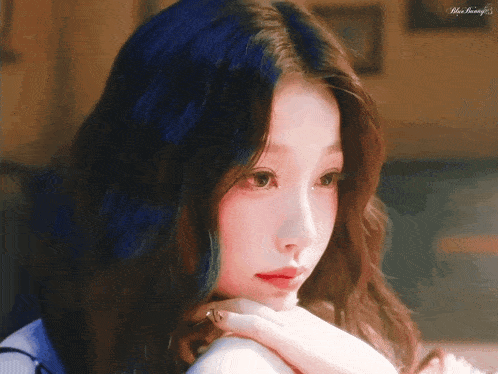 a close up of a woman 's face with the words blue beauty on the bottom left