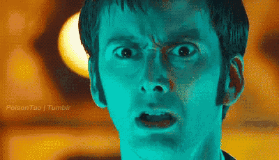 a close up of a man 's face with his mouth open