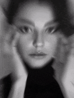 a black and white photo of a woman 's face