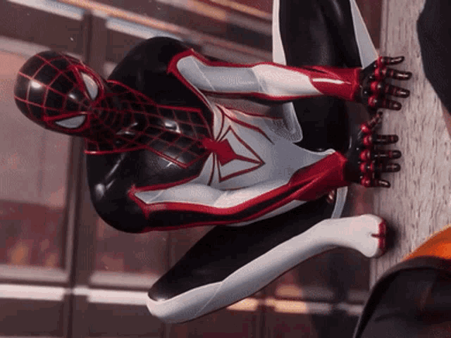 a close up of a spider man 's suit with a red triangle on the chest
