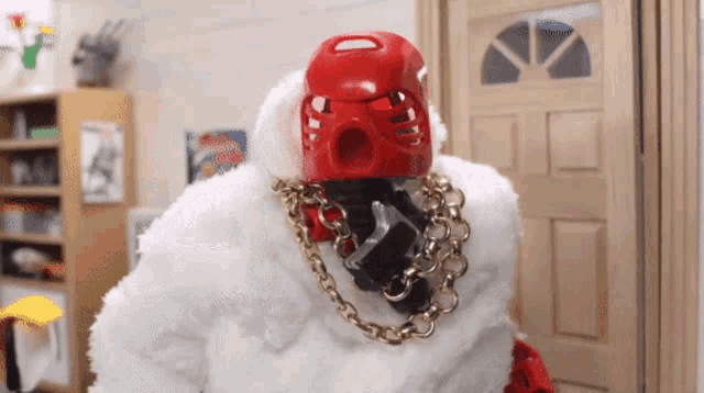 a toy with a red helmet and gold chains on his neck