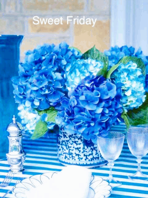 blue flowers in a vase on a table with the words sweet friday on the bottom