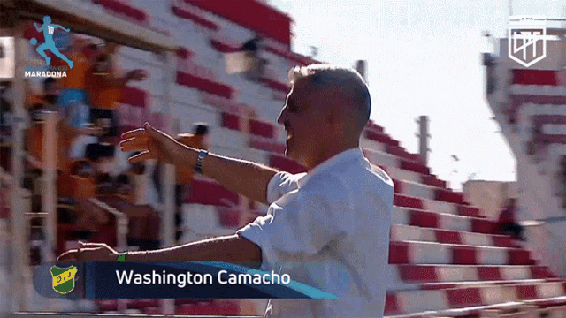 a man stands in front of a washington camacho sign