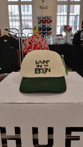a hat that says insane in the bain sits on a box