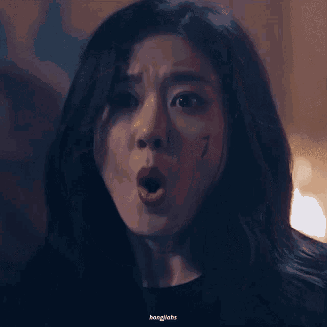 a close up of a woman 's face with a tear running down her cheek