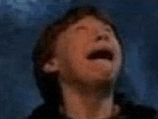 a man is crying with his mouth open in a blurry photo .