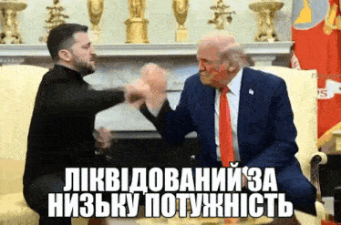 a man in a suit and tie is talking to a man in a black shirt