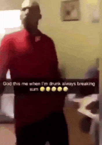 a man in a red shirt is standing in front of a sign that says god this me when i 'm drunk