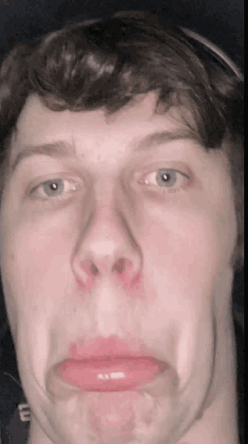 a close up of a man making a funny face with his mouth wide open