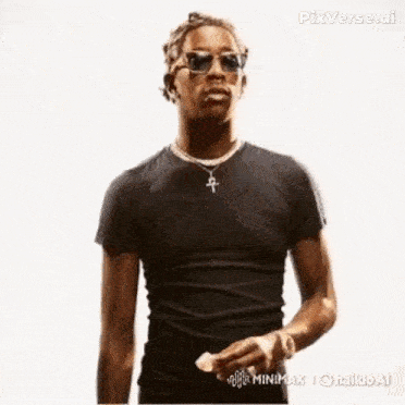 a man wearing headphones and sunglasses is making a funny face while eating something .