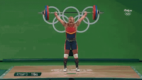 a woman is lifting a barbell in front of a sign that says olympics