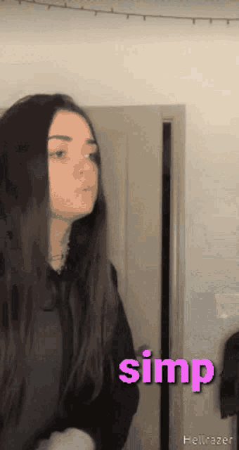 a girl is standing in front of a door with the word simp written on the bottom