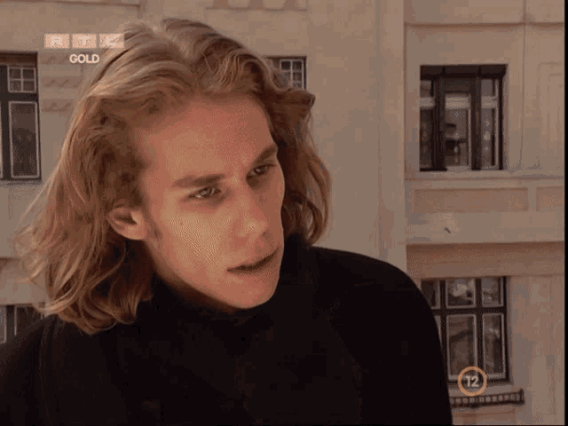 a young man with long blonde hair is on a rtl gold show