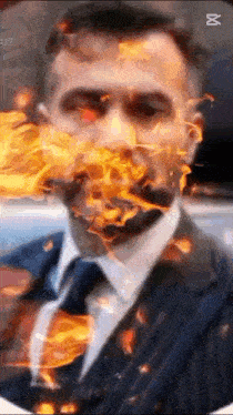a man with flames coming out of his mouth is wearing a suit and tie