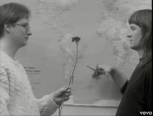 a woman is holding a flower in front of a wall map that says " new times wall map "