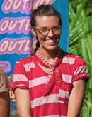 a woman wearing glasses and a red striped shirt is smiling