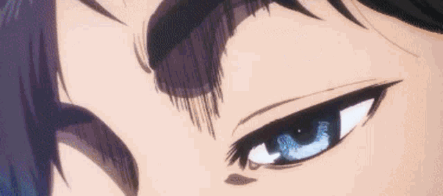 a close up of a person 's blue eyes with a black eyebrow .