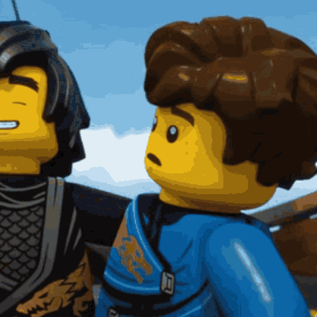 two lego figures are standing next to each other with one wearing a blue outfit with a dragon on it