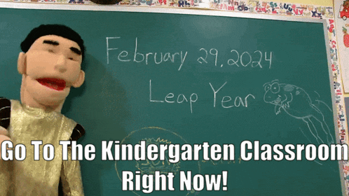 a puppet stands in front of a blackboard that says february 29 2024