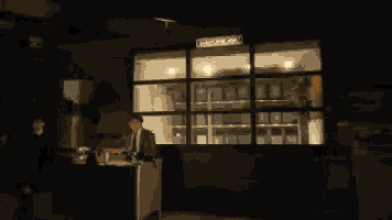 a blurry picture of a person walking in front of a window with a fire coming out of it
