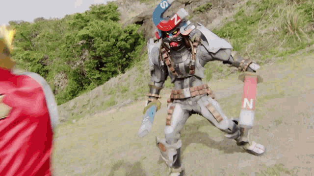 a robot is holding a sword and a magnet with the letter n on it
