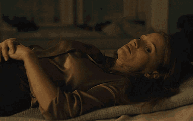 a woman with red hair is laying on her stomach