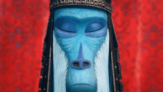 a blue statue of a monkey with a beard and a crown