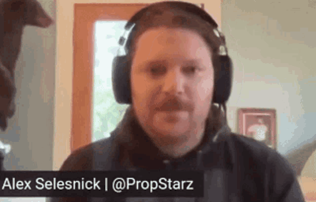 a man wearing headphones with the name alex selenick written on the bottom