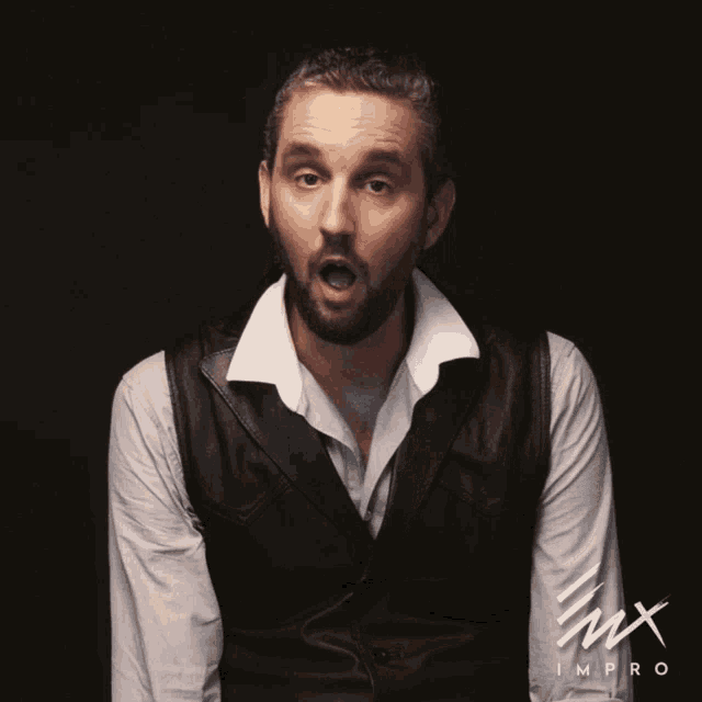 a man wearing a vest and a white shirt is making a surprised face