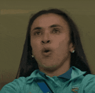 a close up of a woman 's face with her eyes closed and her mouth open .