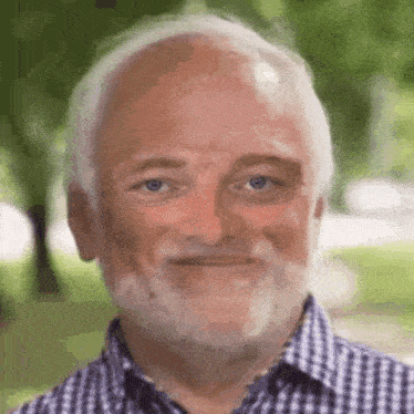 an older man with a beard and bald head is making a funny face .