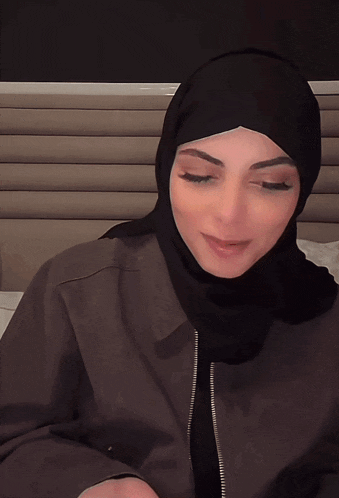 a woman wearing a black hijab has a heart on her head