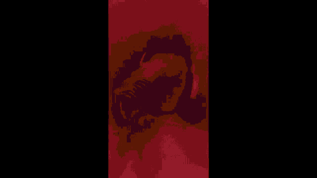 a blurry picture of a person standing in a dark room .