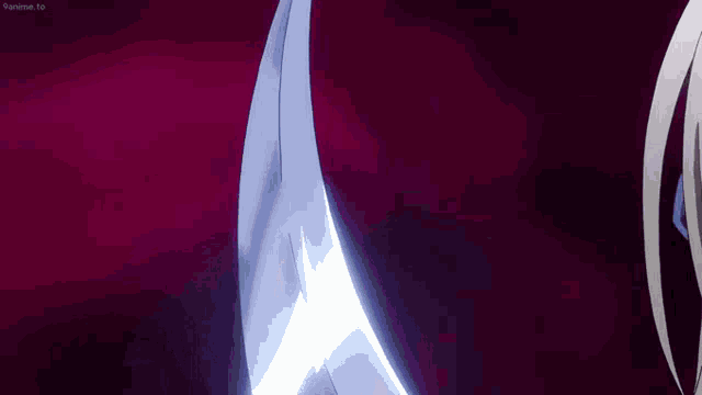 a close up of a person holding a sword in a dark room .