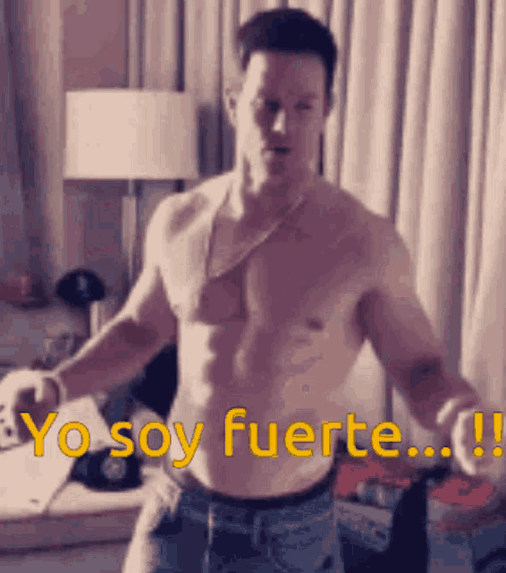 a shirtless man is dancing in a room with the words yo soy fuerte written on the bottom