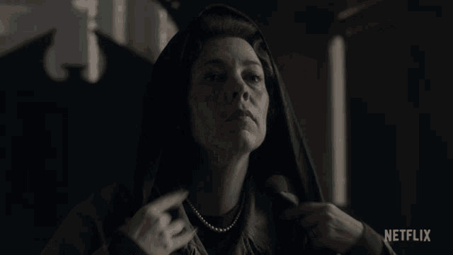 a woman wearing a hooded jacket with netflix written on the bottom right