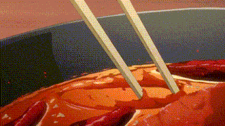 a pair of chopsticks sticking out of a pot of hot sauce .