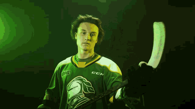 a hockey player wearing a green jersey with ccm on the front