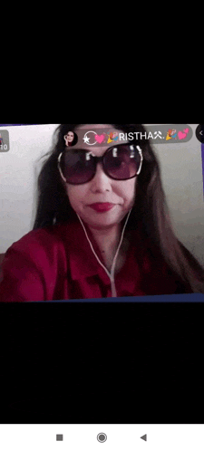 a woman wearing sunglasses and earphones is talking on a video call on her phone .