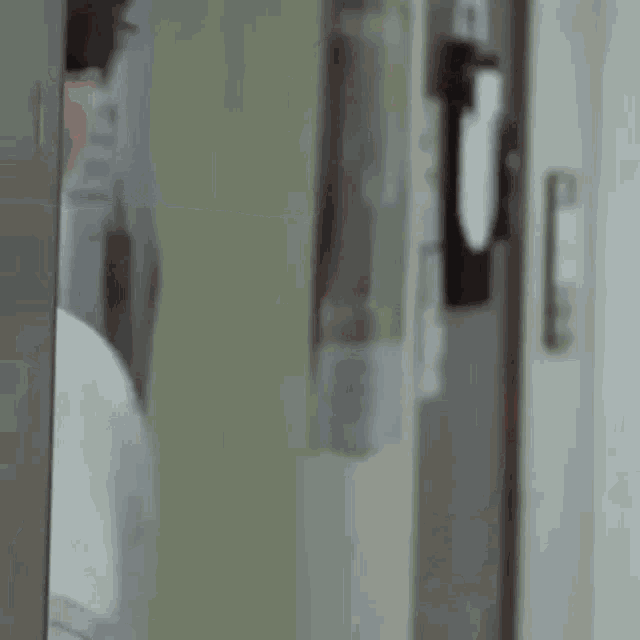 a man wearing sunglasses and a mustache is standing in a doorway .