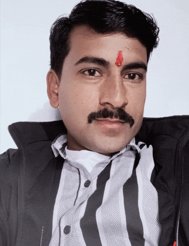 a man with a red circle on his forehead