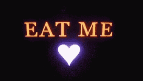 a purple heart is surrounded by the words `` eat me '' on a dark background .