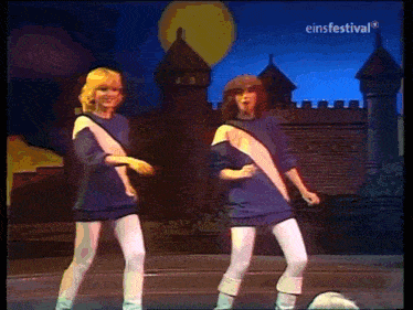 two women are dancing on a stage in front of a castle with einfestival written on the bottom